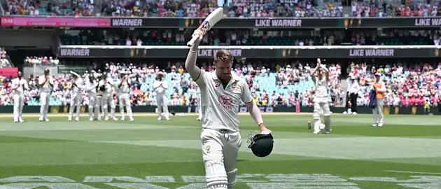 David Warner walks back after playing his final Test innings