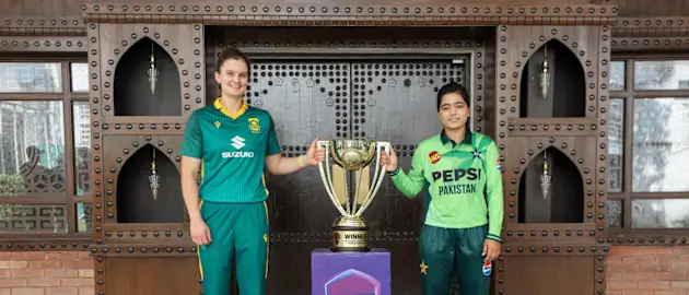 South Africa's Laura Wolvaardt and Pakistan's Fatima Sana posing with the ODI series trophy in Lahore