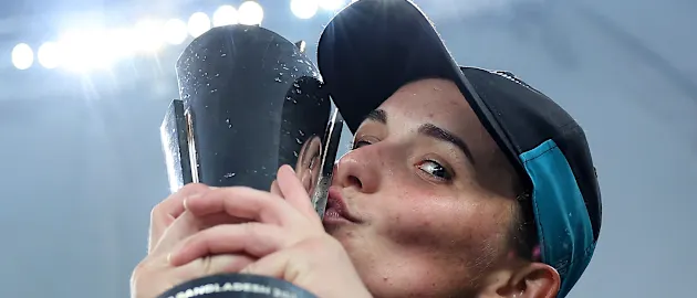 Melie Kerr of New Zealand kisses the ICC Women's T20 World Cup Trophy as she celebrates after defeating South Africa during the ICC Women's T20 World Cup Final 2024 match