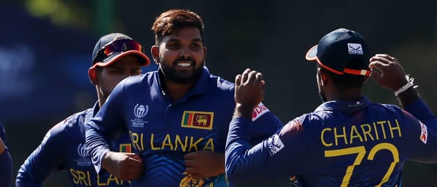 Wanindu Hasaranga of Sri Lanka celebrates with teammates after taking the wicket of Shoaib Khan of Oman during the ICC Men Cricket World Cup Qualifier Zimbabwe