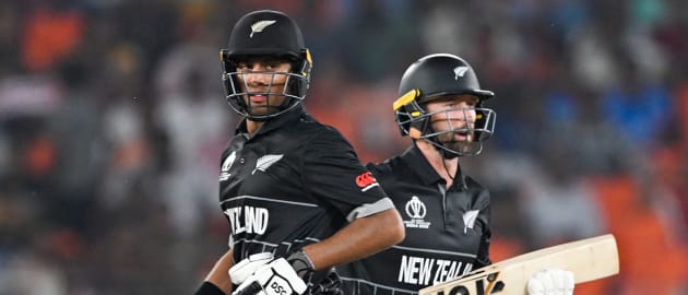 New Zealand's Rachin Ravindra (L) and Devon Conway run between the wickets during the 2023 ICC men's cricket World Cup one-day international