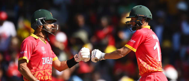 Sikandar Raza and Sean Williams of Zimbabwe fist bump between overs during the ICC Men's Cricket World Cup Qualifier Zimbabwe 2023 Super 6 match between Zimbabwe and Sri Lanka