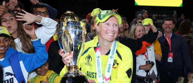 Alyssa Healy of Australia poses with the trophy in front of fans after Australia won the 2022 ICC Women's Cricket World Cup Final match between Australia and England at Hagley Oval on April 03, 2022 in Christchurch, New Zealand.