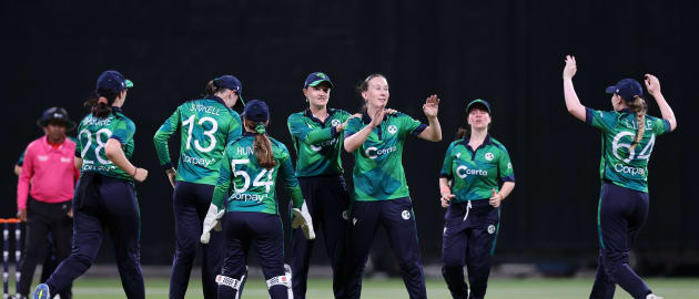 Orla Prendergast of Ireland celebrates with teammates after taking the wicket of Sterre Kalis of the Netherlands.