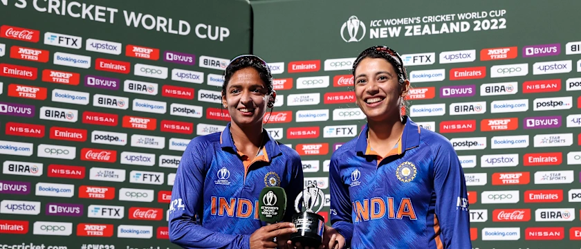 Harmanpreet Kaur (L) and Smriti Mandhana of India pose with the Player of the Match Award during the 2022 ICC Women's Cricket World Cup match between West Indies and India at Seddon Park on March 12, 2022 in Hamilton, New Zealand.