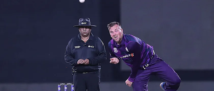 Scotland's Mark Watt delivers a ball during the ICC men's Twenty20 World Cup cricket match between Oman and Scotland at the Oman Cricket Academy Ground in Muscat on October 21, 2021.