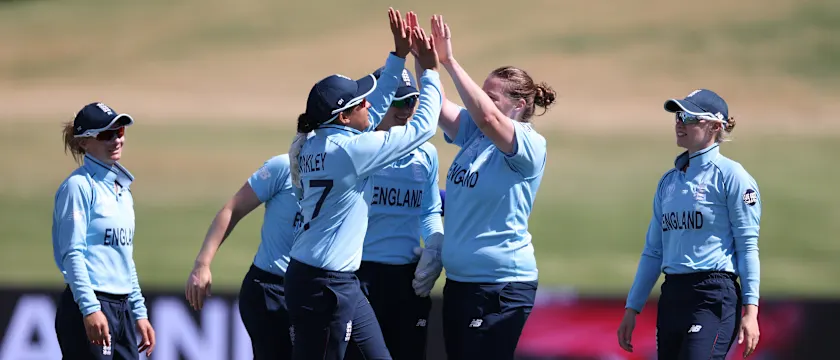 Anya Shrubsole (2R) of England celebrates with teammates after dismissing Mithali Raj of India during the 2022 ICC Women's Cricket World Cup match between England and India at Bay Oval on March 16, 2022 in Tauranga, New Zealand.