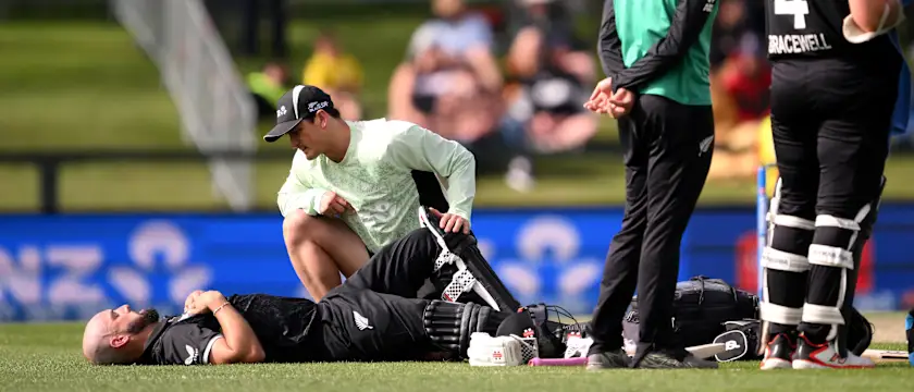 Daryl Mitchell receives medical attention during first ODI against West Indies at Hagley Oval
