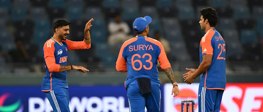 India's Axar Patel (L), captain Suryakumar Yadav and Shivam Dube celebrate the dismissal of UAE's Asif Khan 