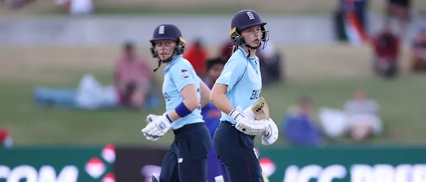 Amy Jones (R) and Heather Knight of England run between wickets during the 2022 ICC Women's Cricket World Cup match between England and India at Bay Oval on March 16, 2022 in Tauranga, New Zealand.