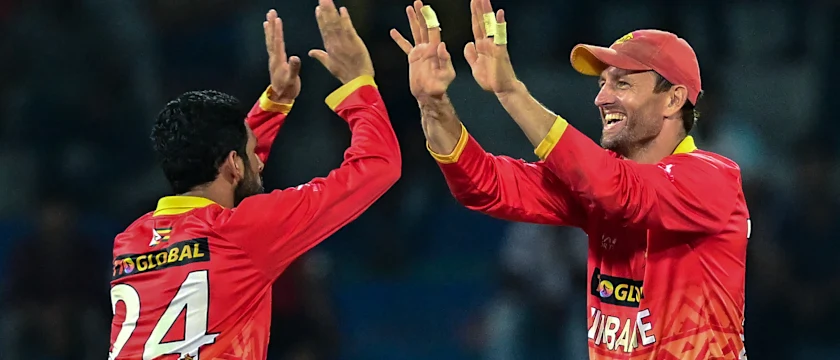 Zimbabwe's captain Craig Ervine (R) and Sikandar Raza celebrate after the dismissal of Sri Lanka's Dasun Shanaka during the second one-day international (ODI) cricket match between Sri Lanka and Zimbabwe at the R. Premadasa Stadium in Colombo