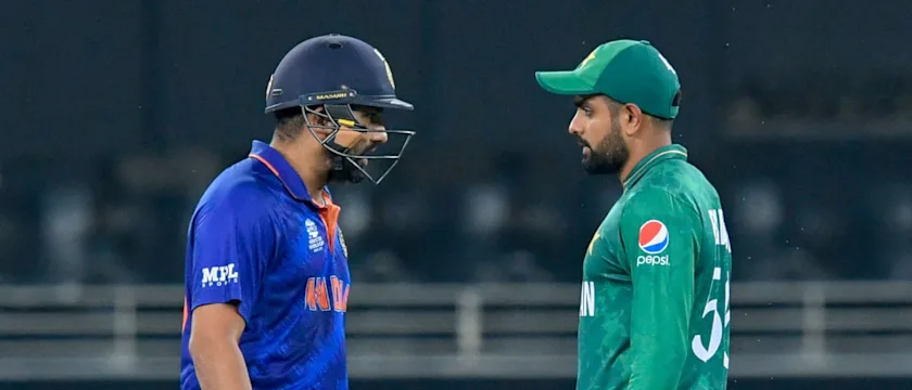 India's Rohit Sharma (L) walks past Pakistan's captain Babar Azam_1920x1080