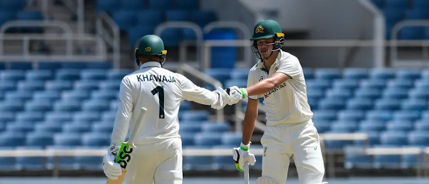 Usman Khawaja (L) and Sam Konstas (R) of Australia knock gloves during the first day of the 3rd Test between West Indies and Australia 