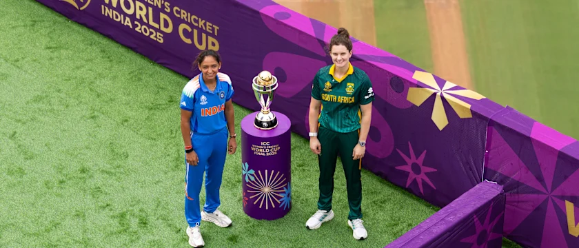 Harmanpreet Kaur and Laura Wolvaardt pose with the CWC25 trophy