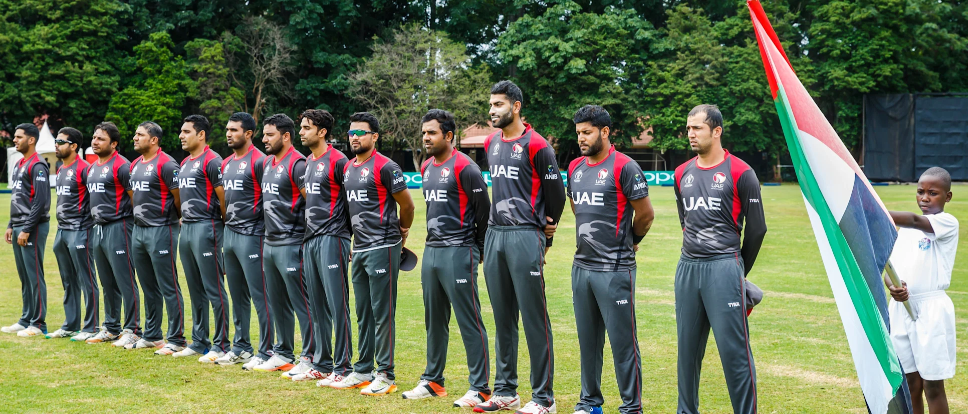 Logo of UAE players stand during the singing of their national anthem ahead of a Group A World Cup Qualifier cricket match between United Arab Emirates and Ireland at Old Hararians Sports Club in Harare March 12 2018 (©ICC).