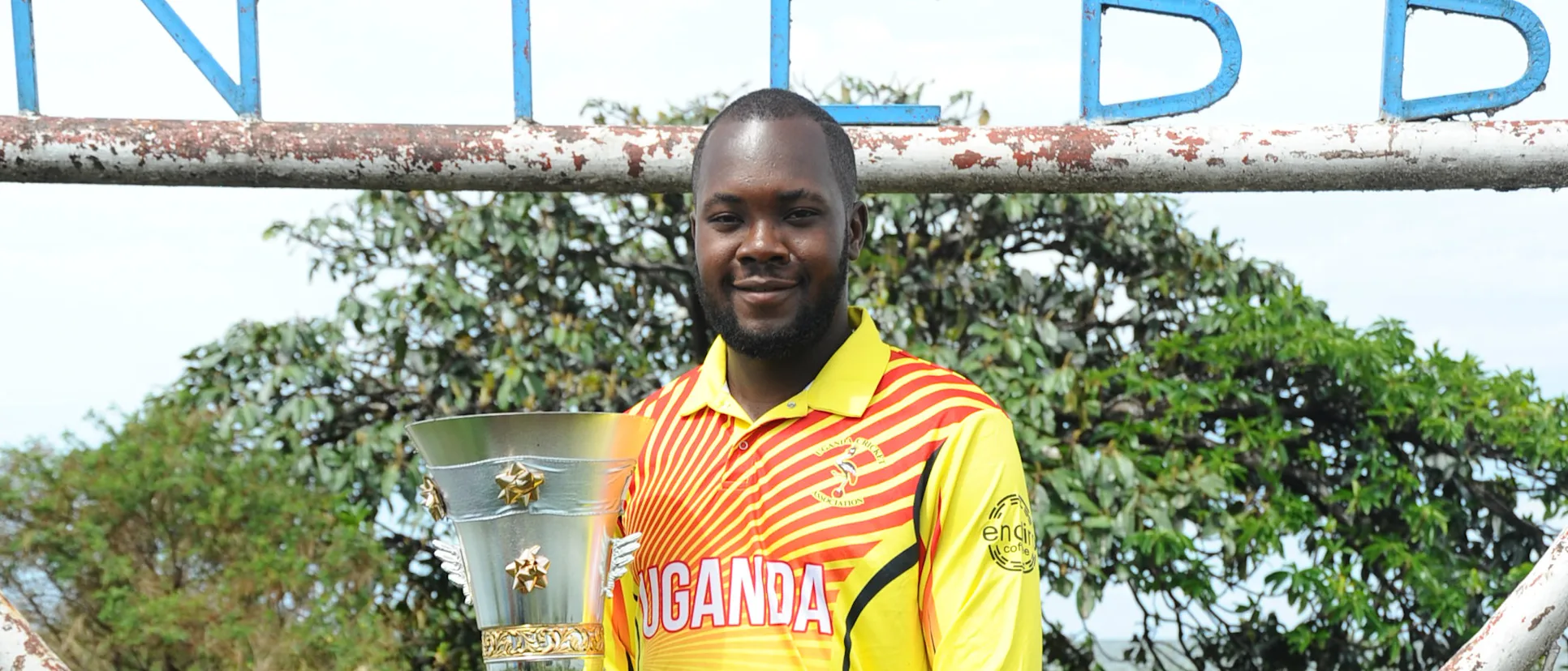 Logo of Uganda captain Roger Mukasa with the ICC T20 World Cup Africa Final Qualifier trophy