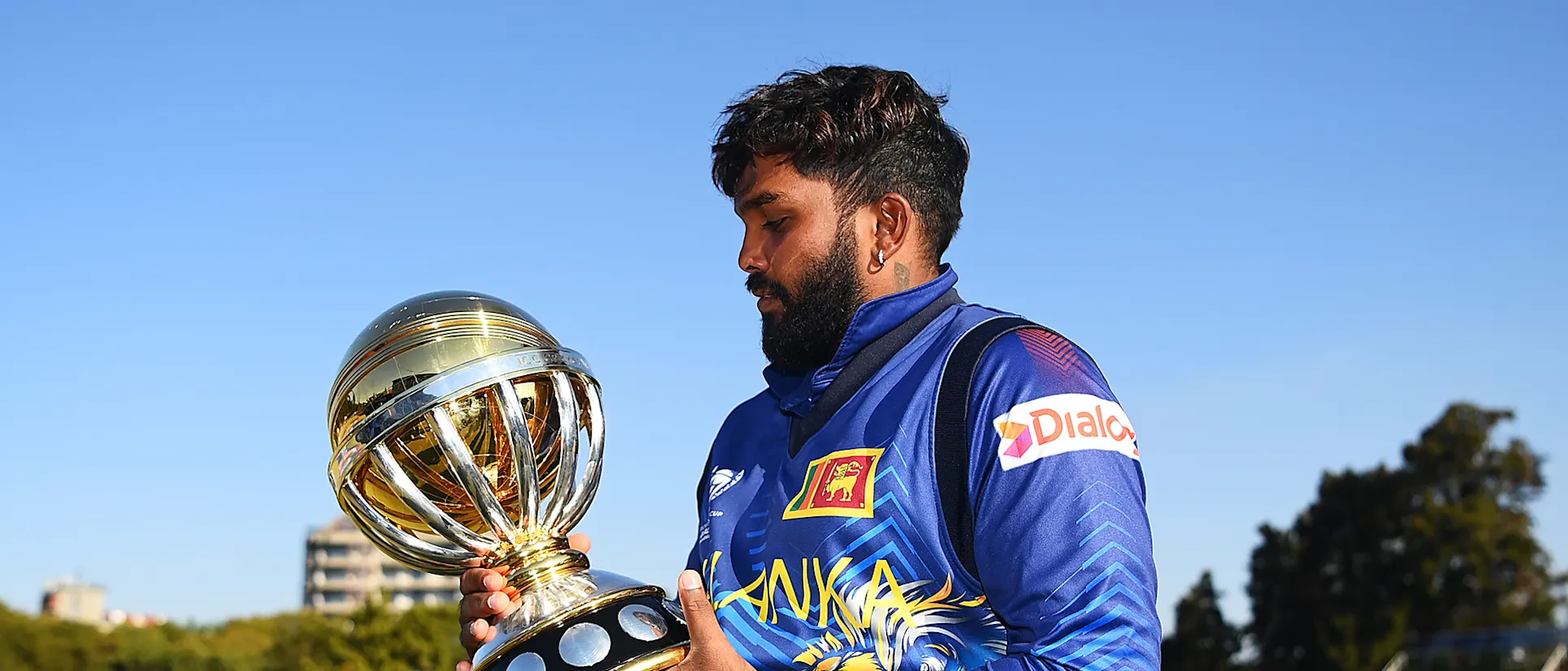 Logo of Wanindu Hasaranga of Sri Lanka celebrates with the ICC Men´s Cricket World Cup Qualifier Trophy after defeating Netherlands during the ICC Men´s Cricket World Cup Qualifier