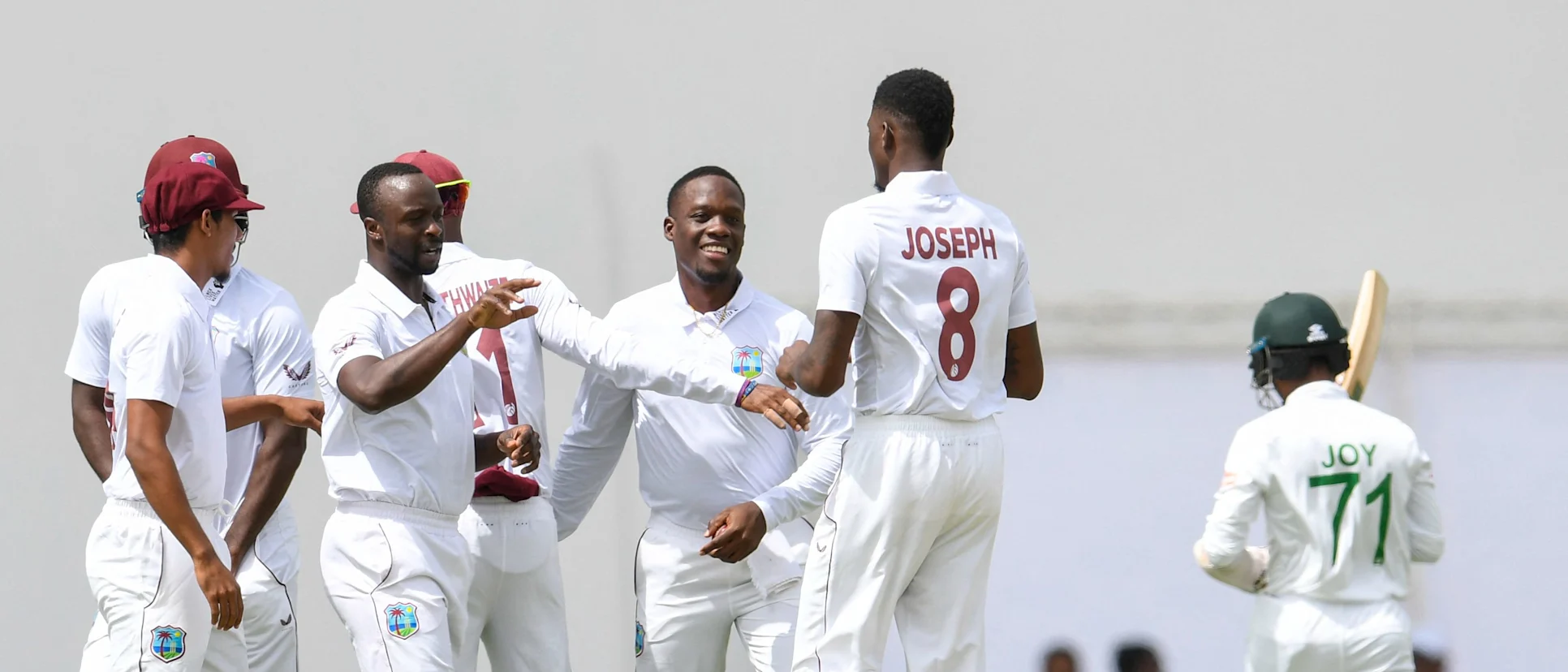 Kemar Roach and Nkrumah Bonner of West Indies celebrate with teammate Alzarri Joseph the dismissal of Mahmudul Hasan Joy