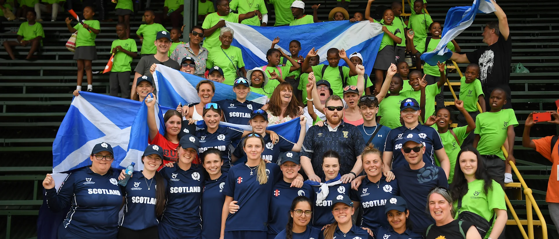 Logo of Players of Scotland pose with their families following the ICC Women's U19 T20 World Cup 2023 4th place playoff match between USA and Scotland at Willowmoore Park on January 20, 2023 in Benoni, South Africa.