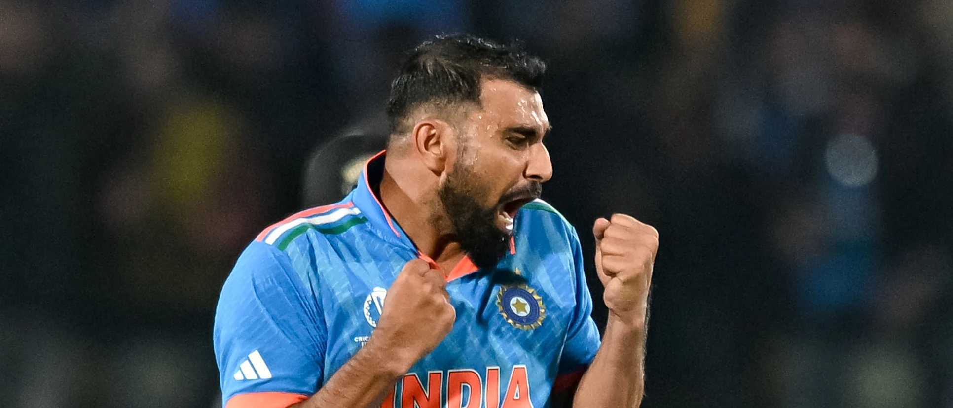 Logo of India's Mohammed Shami celebrates after taking the wicket of New Zealand's Matt Henry during the 2023 ICC Men's Cricket World Cup one-day international (ODI) match between India and New Zealand