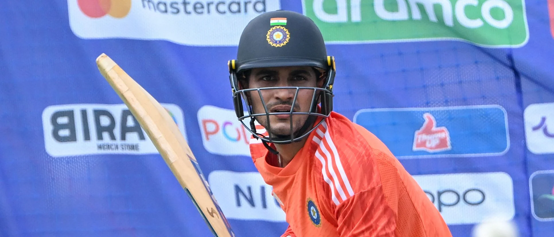 Logo of India's Shubman Gill bats during a practice session at the Maharashtra Cricket Association Stadium on the eve of their 2023 ICC men's cricket World Cup match against Bangladesh,