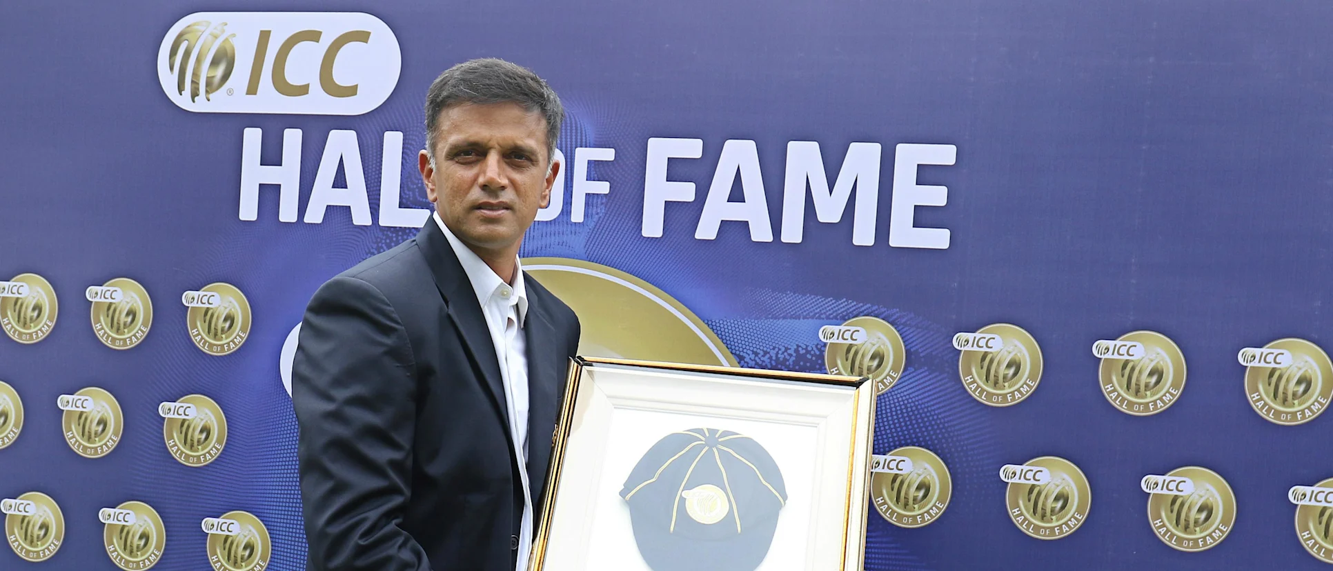 Logo of Rahul Dravid poses for the photographers with his ICC Cricket Hall of Fame cap
