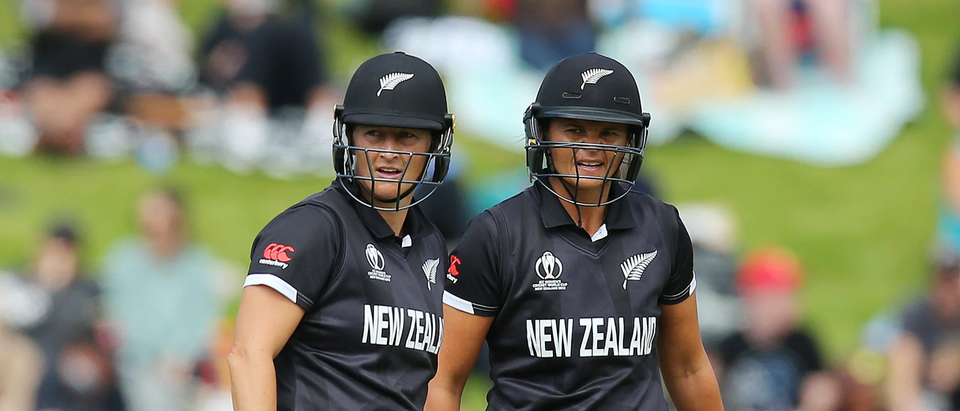 Logo of Sophie Devine (L) and Suzie Bates of New Zealand look on during the 2022 ICC Women's Cricket World Cup match between New Zealand and Australia 1920x1080