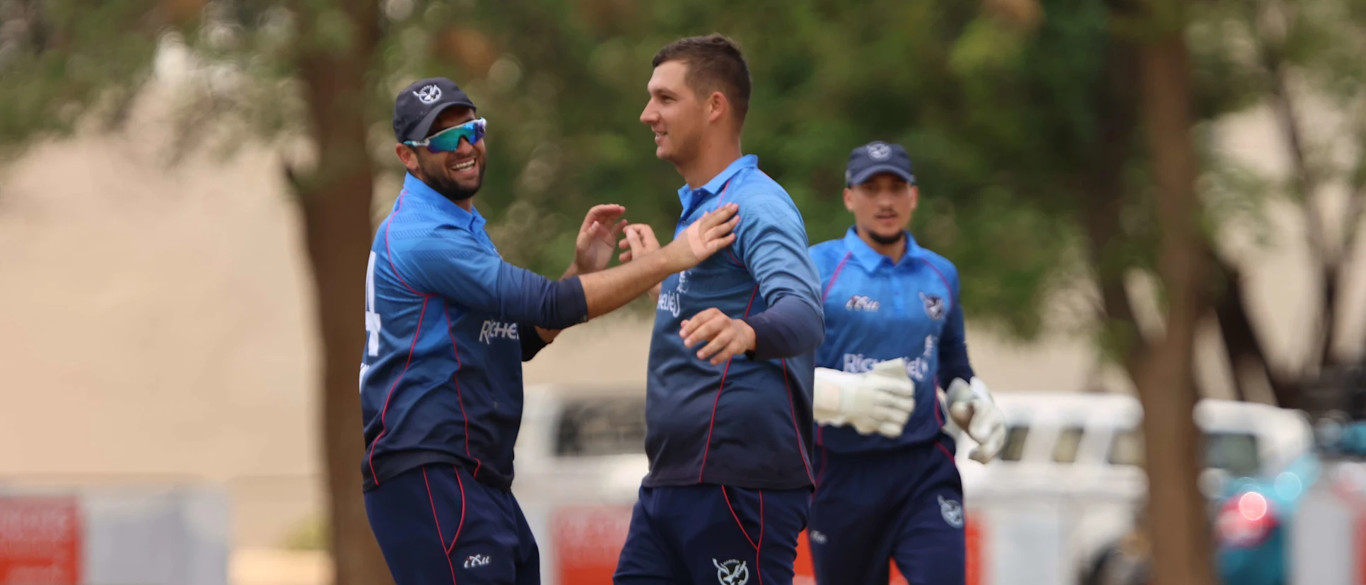 Logo of Namibia players celebrate at the fall of a wicket during their game against Tanzania