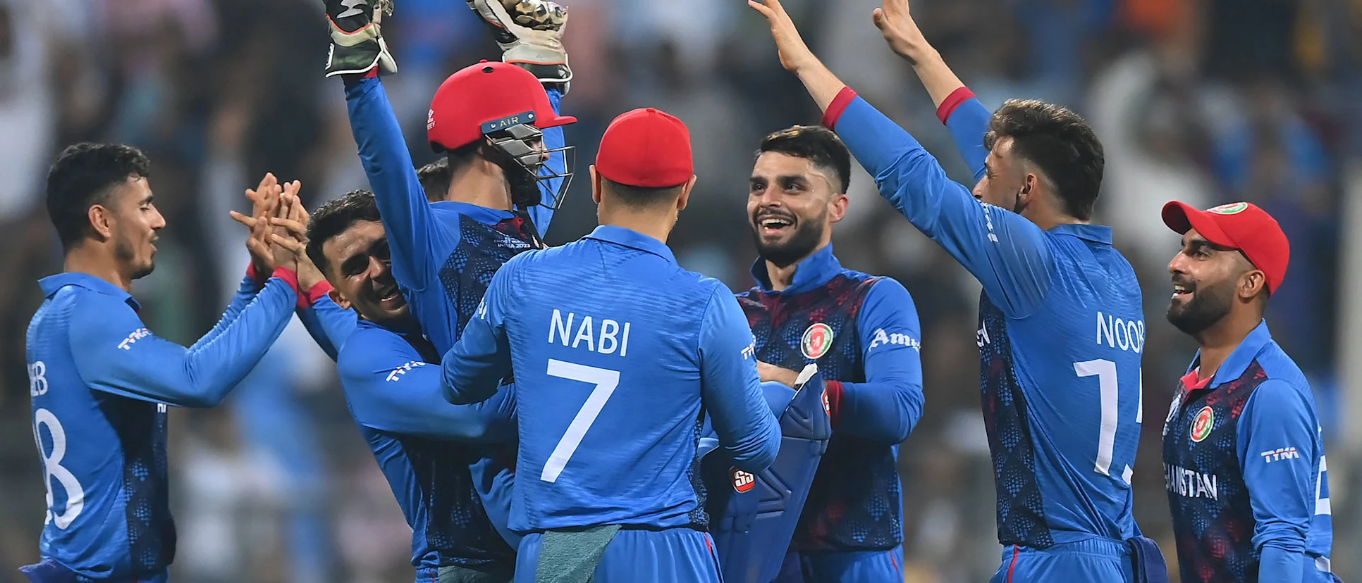 Logo of Rashid Khan of Afghanistan celebrates the wicket of Mitchell Starc of Australia during the ICC Men's Cricket World Cup India 2023 between Australia and Afghanistan