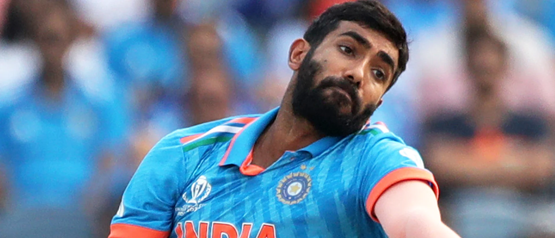 Logo of Jasprit Bumrah of India in bowling action during the ICC Men's Cricket World Cup India 2023 between India and Bangladesh