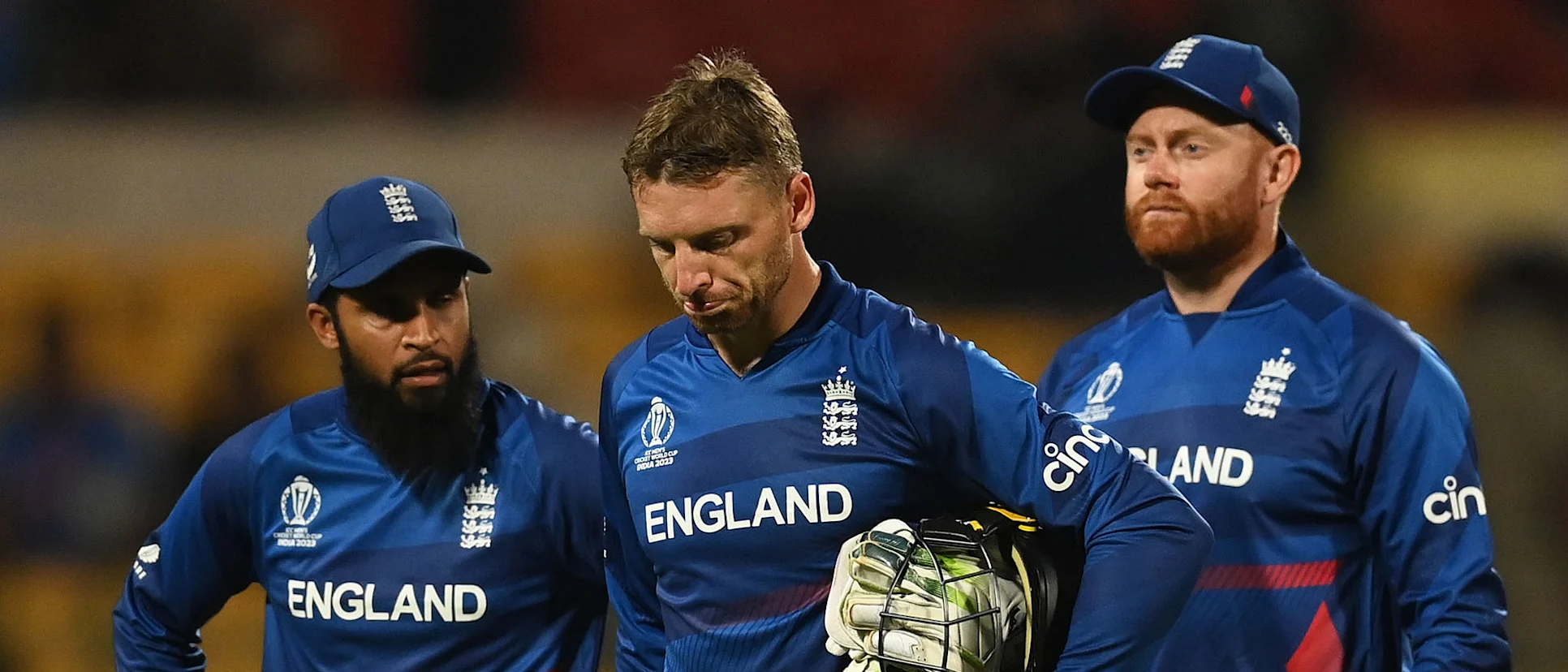 Logo of Adil Rashid, Jonny Bairstow and Jos Buttler of England cut dejected figures following the ICC Men's Cricket World Cup India 2023 between England and Sri Lanka
