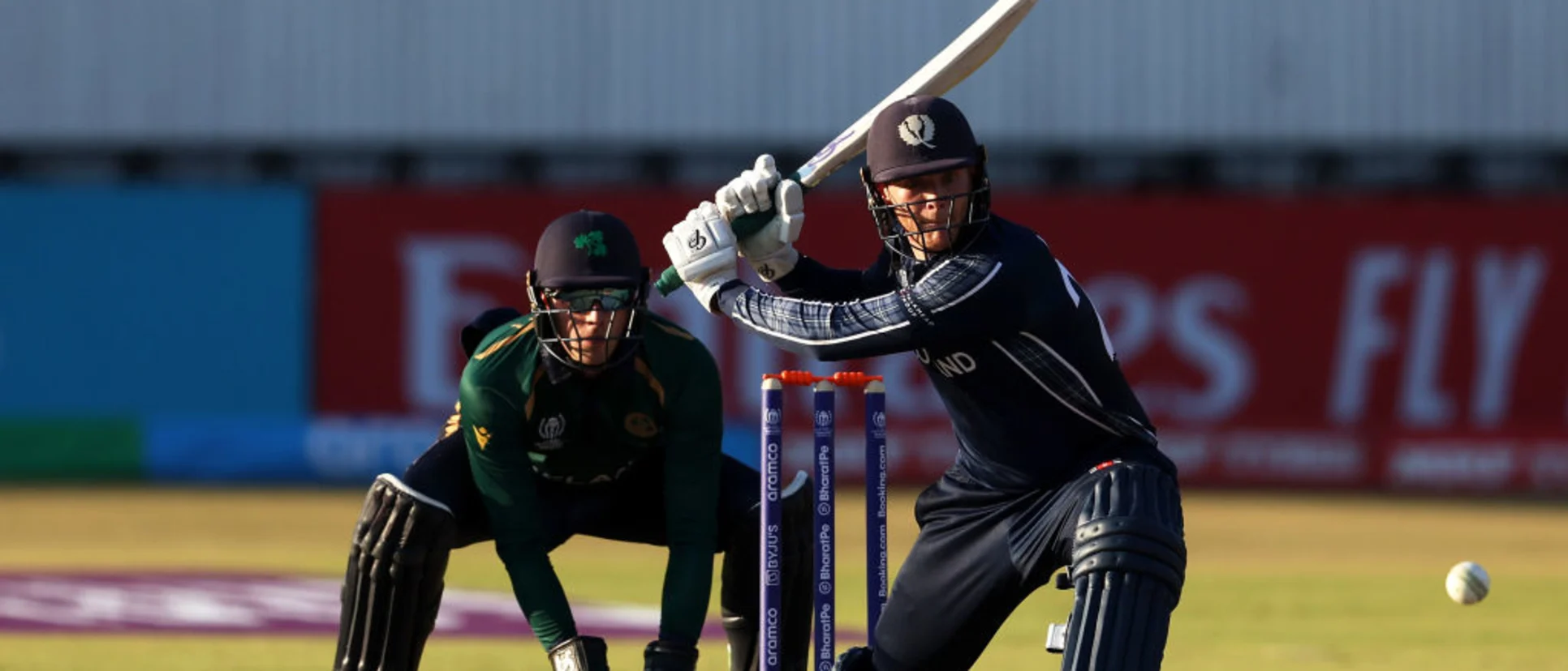 Logo of Michael Leask of Scotland sweeps the ball for a four during the ICC Men's Cricket World Cup Qualifier Zimbabwe 2023 match between Ireland and Scotland at Queen’s Sports Club on June 21, 2023 in Bulawayo, Zimbabwe.