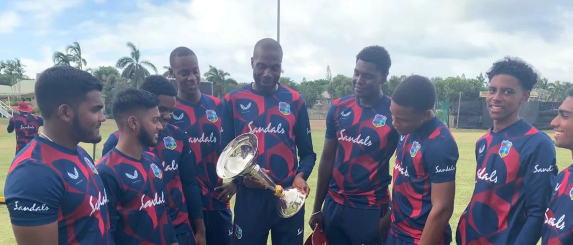 Logo of Curtly Ambrose holds U19 Men's CWC Trophy