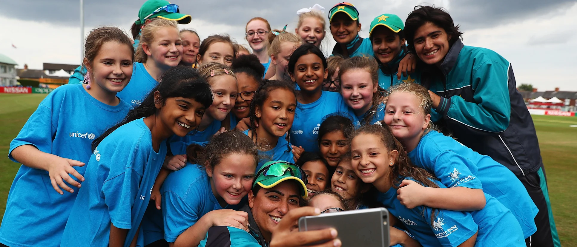 Logo of Sana Mir and kids at a Cricket for Good session at ICC Women's World Cup 2017