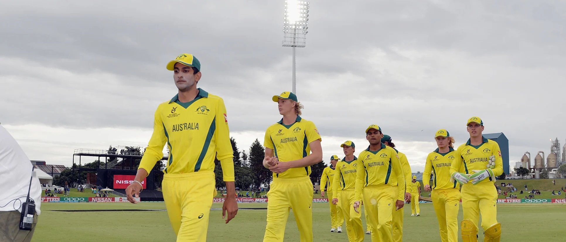 Logo of Jason Sangha and Australia's players leave the field