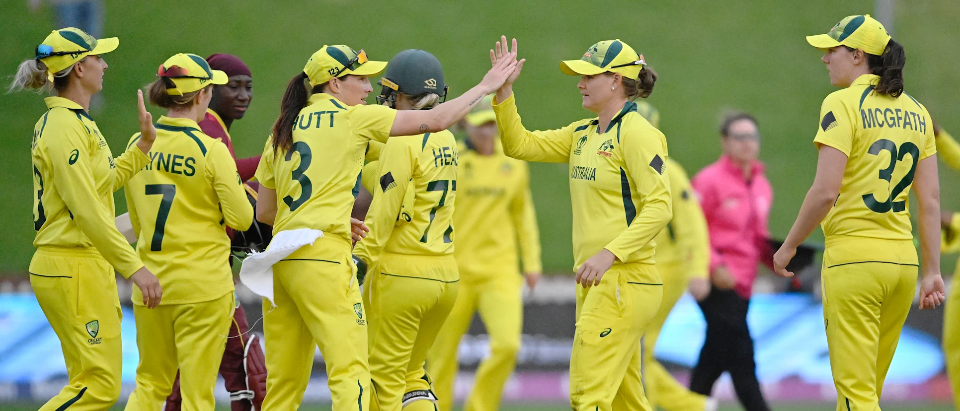 Logo of Jess Jonassen of Australia celebrates with teammate Megan Schutt after catching out Stafanie Taylor of the West Indies and to win the 2022 ICC Women's Cricket World Cup match between Australia and the West Indies at Basin Reserve on March 30, 2022.