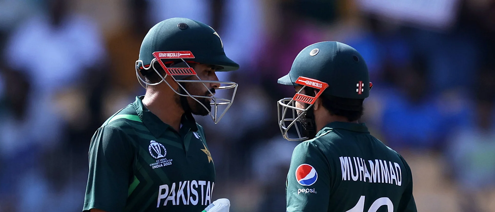 Logo of Babar Azam and Mohammad Rizwan of Pakistan interact during the ICC Men's Cricket World Cup India 2023 between Pakistan and South Africa