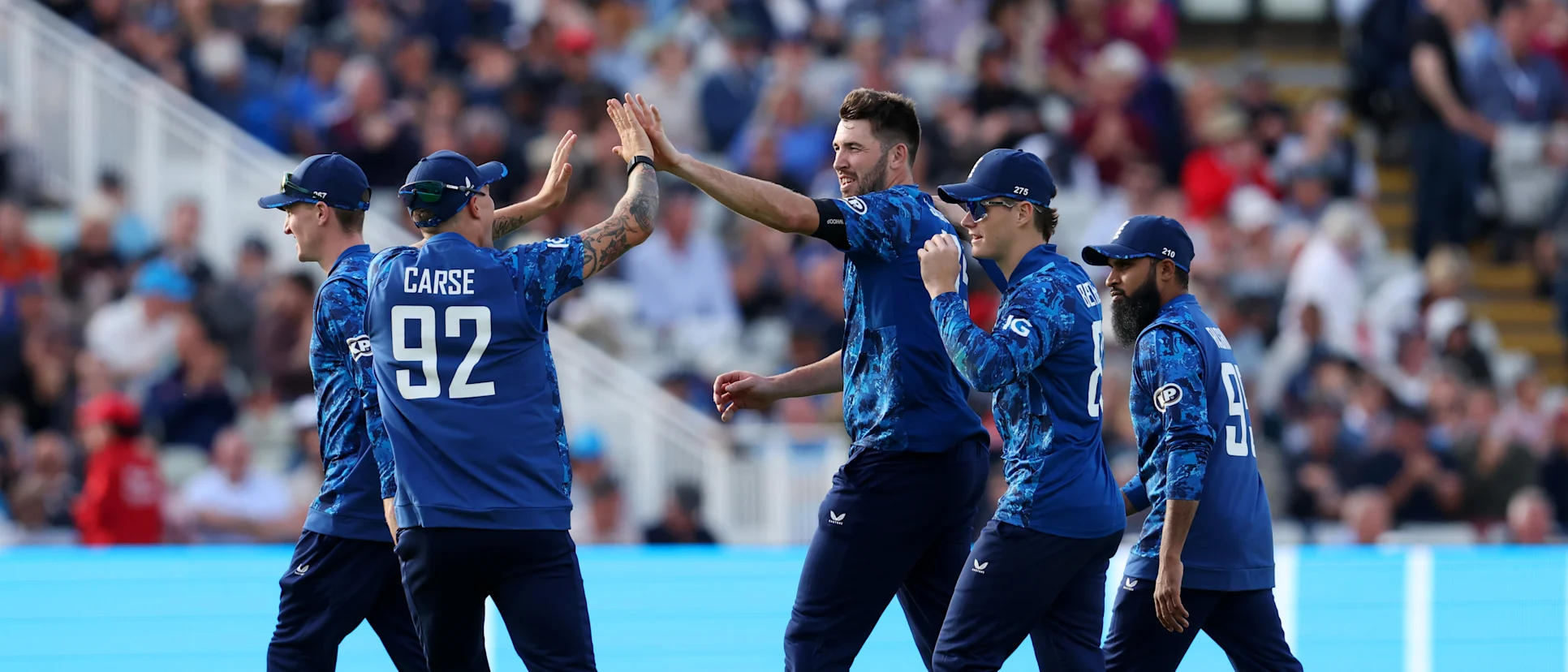 Logo of Jamie Overton celebrates a wicket along with his teammates