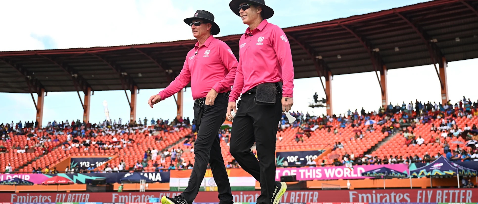 Logo of Umpires Chris Gaffaney (R) and Rod Tucker walk out on to the field during the ICC Men's T20 Cricket World Cup West Indies & USA 2024 Semi-Final match between India and England at Providence Stadium on June 27, 2024 in Georgetown, Guyana.