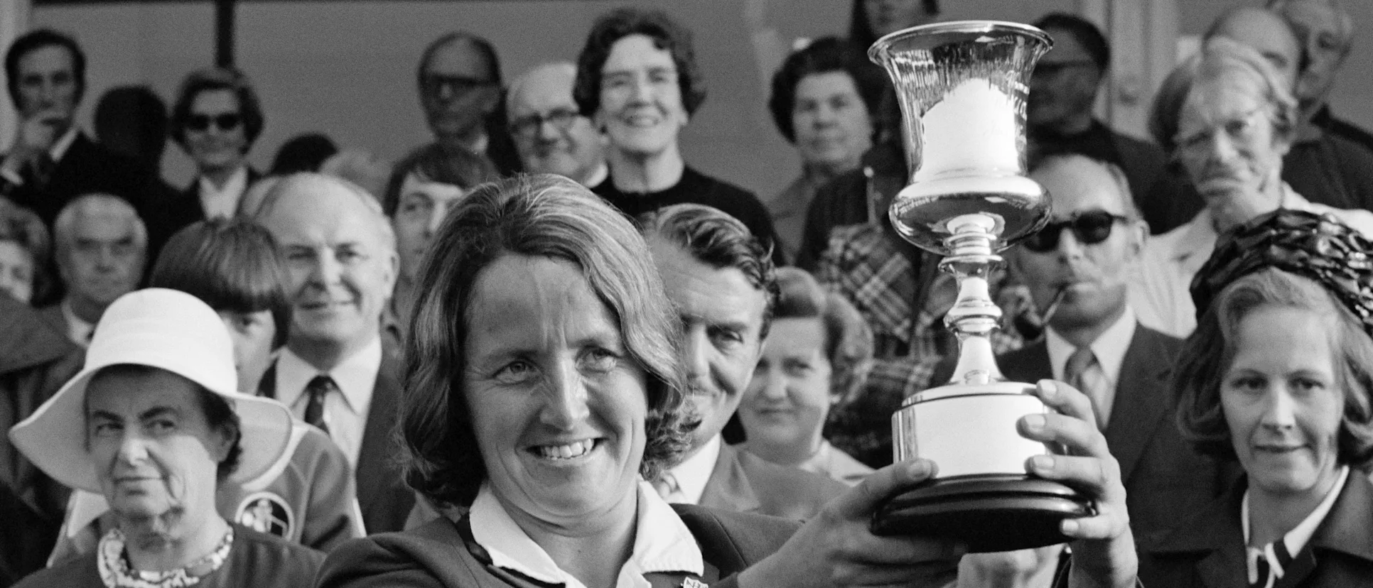 Logo of 1973 – Rachael Heyhoe-Flint poses lifts the Jack Hayward Trophy as England win the first ODI World Cup.