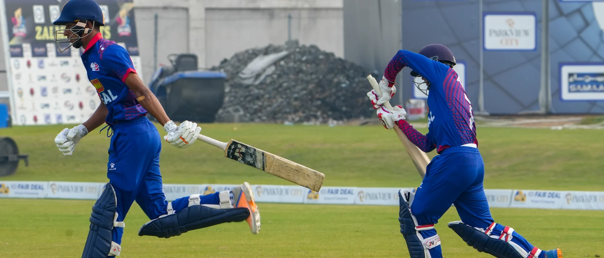 Logo of Nepal batters walk out to bat against UAE in the ICC U19 Men's CWC Asia Division 1 Qualifier 2023
