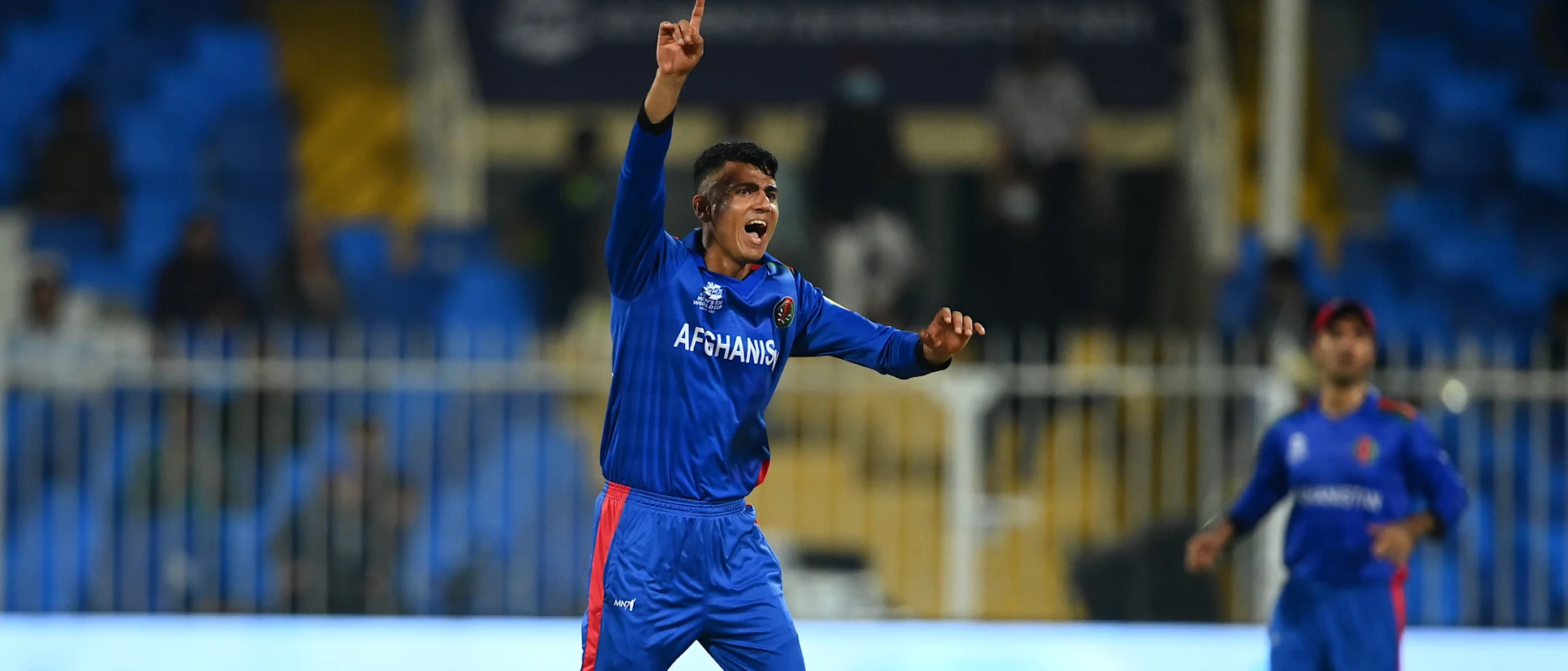 Logo of Mujeeb Ur Rahman of Afghanistan successfully appeals for the LBW of Calum MacLeod of Scotland during the ICC Men's T20 World Cup match between Afghanistan and Scotland at Sharjah Cricket Stadium on October 25, 2021 in Sharjah, United Arab Emirates.