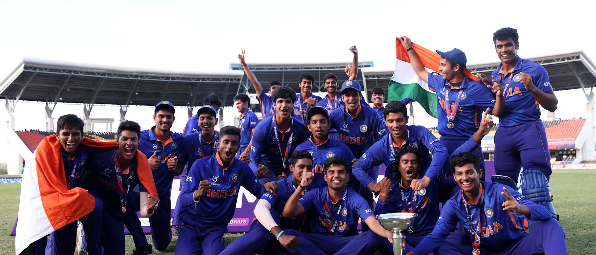 Logo of Players of India celebrate with the ICC U19 Men's World Cup Trophy following the ICC U19 Men's Cricket World Cup Final match between England and India at Sir Vivian Richards Stadium on February 05, 2022 in Antigua, Antigua and Barbuda.