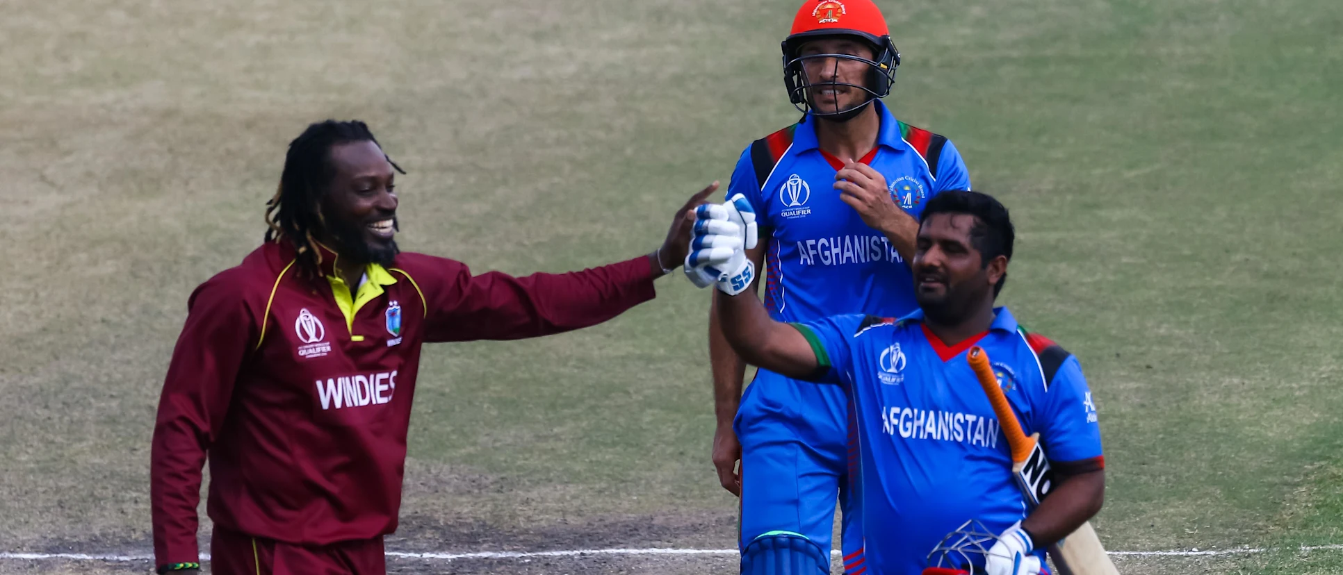 Logo of Afghan batsman M.Shahzad receives a consiliatory high five from Chris Gayle as he leaves the pitch after making 84 runs during the ICC Cricket World Cup Qualifier Trophy, Harare Sports Club March 25 2018 (©ICC).