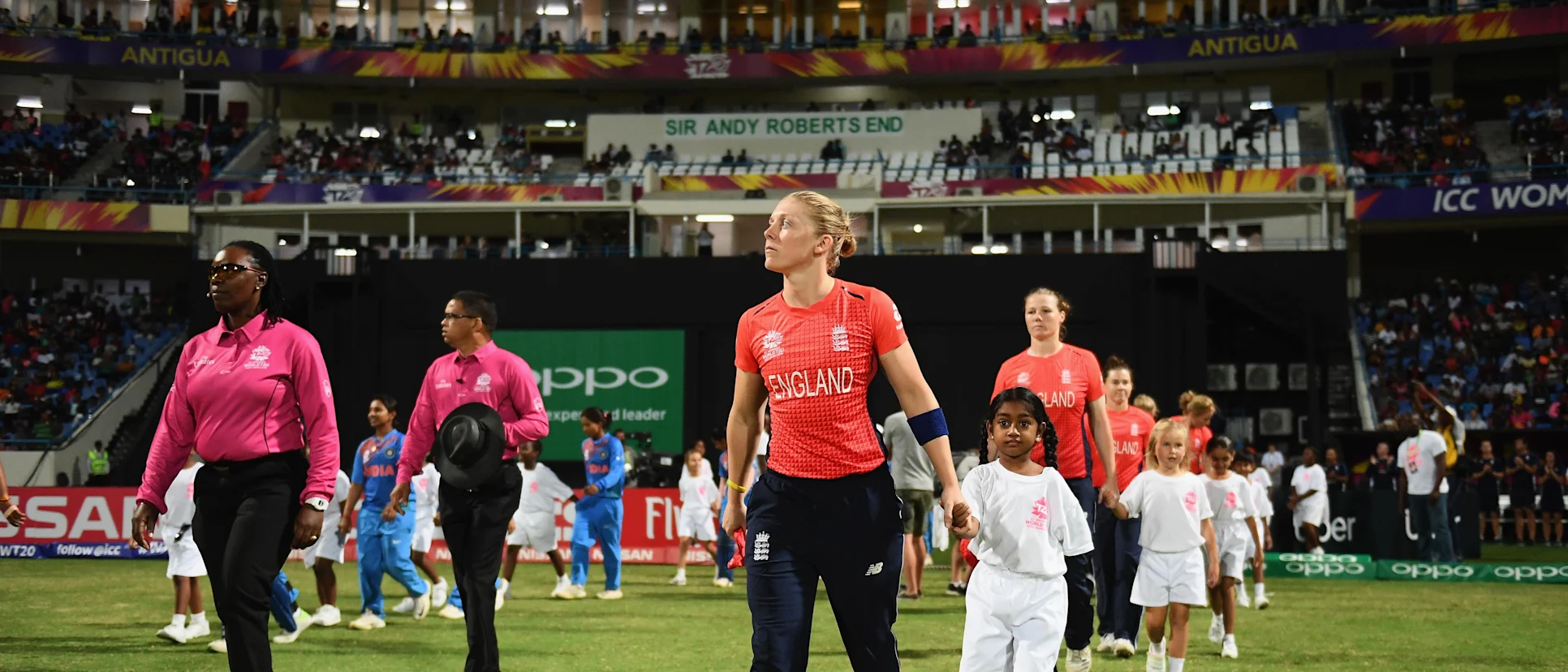Logo of Heather Knight of England leads out her side for the national anthems during the ICC Women's World T20 2018 Semi-Final match between England and India at Sir Viv Richards Cricket Ground on November 22, 2018 in Antigua, Antigua and Barbuda.