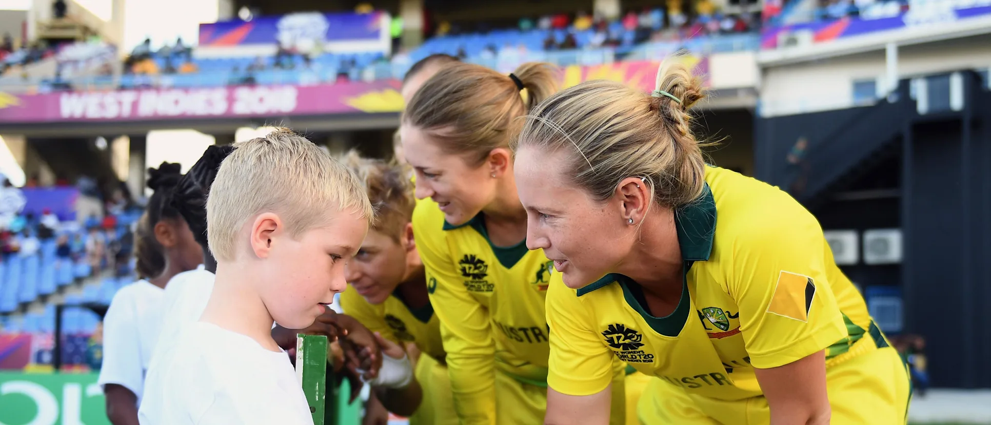 Logo of Meg Lanning of Australia shakes hands with a young mascot during the ICC Women's World T20 2018 Semi-Final match between Windies and Australia at Sir Viv Richards Cricket Ground on November 22, 2018 in Antigua, Antigua and Barbuda.
