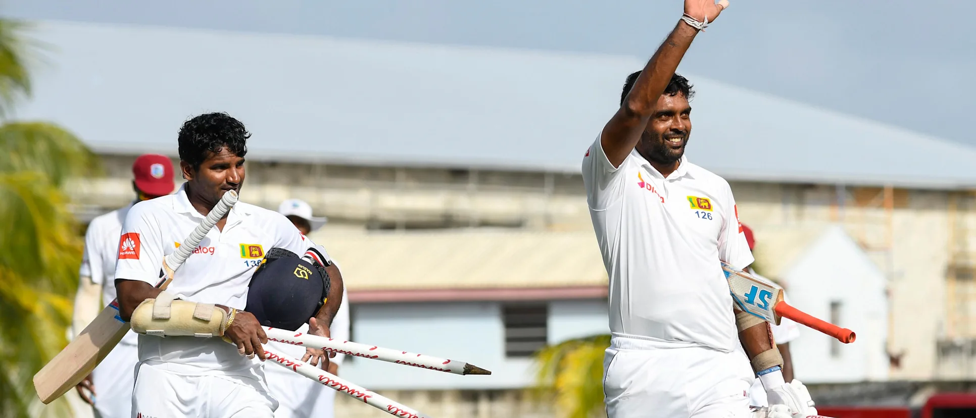 Logo of Dilruwan Perera and Kusal Perera celebrate victory