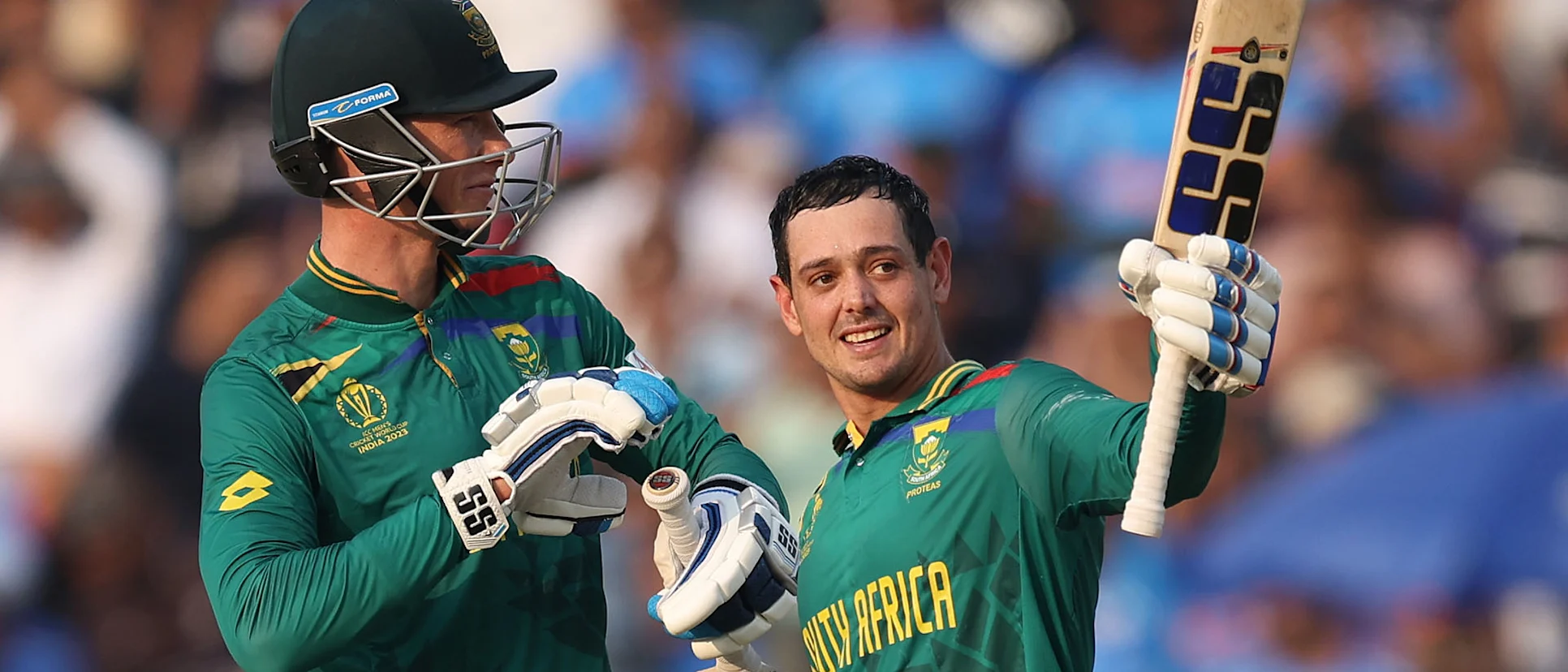 Logo of Quinton de Kock of South Africa celebrates their century with team mate Rassie van der Dussen during the ICC Men's Cricket World Cup India 2023 between New Zealand and South Africa