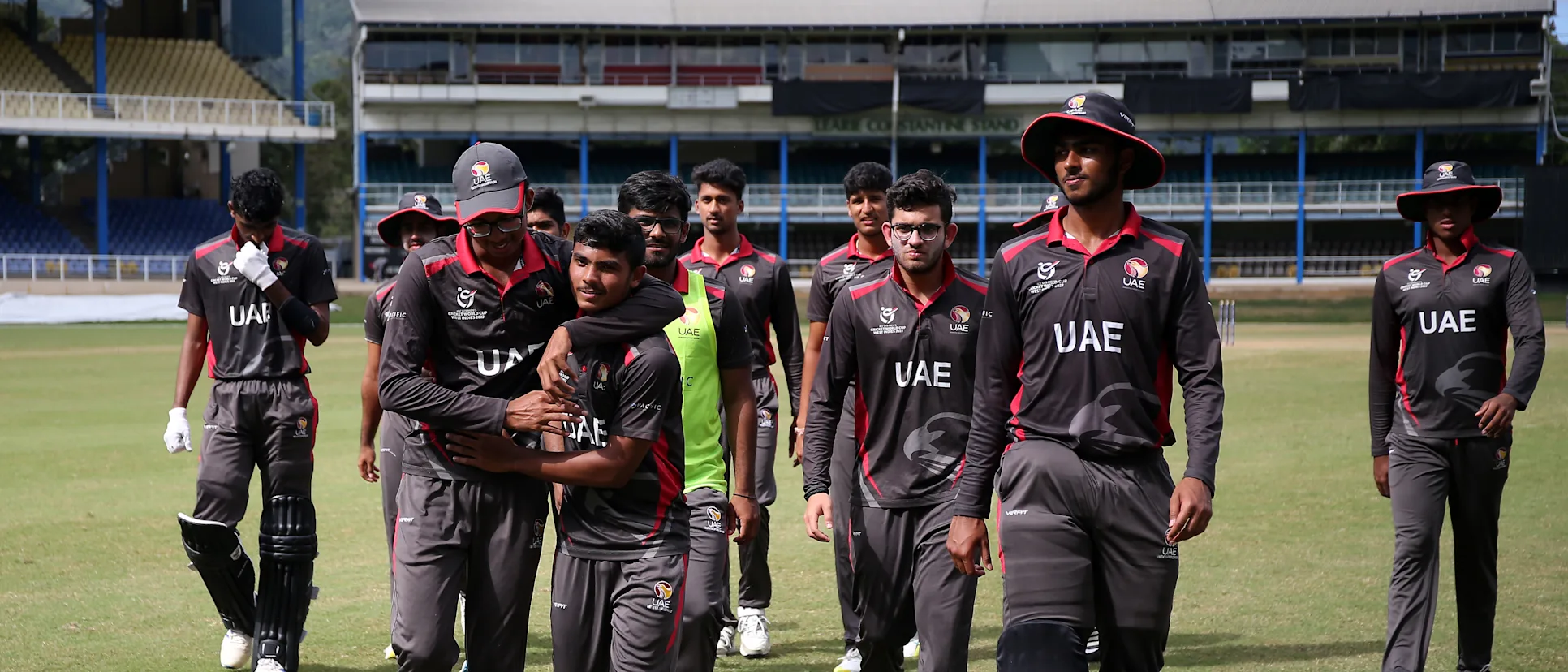 Logo of Players of United Arab Emirates celebrate following the ICC U19 Men's Cricket World Cup Plate Quarter Final 1 match between United Arab Emirates and Uganda at Queen's Park Oval on January 25, 2022 in Port of Spain, Trinidad And Tobago.