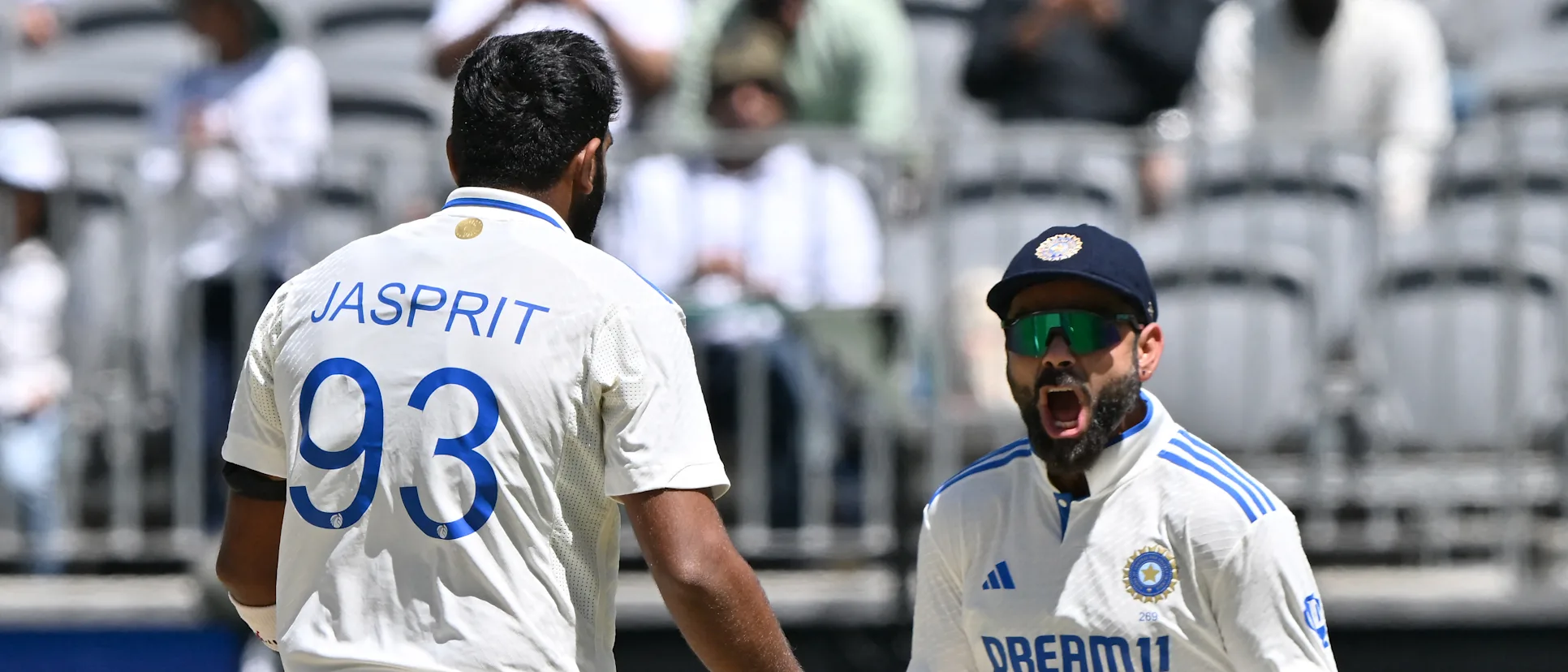 Logo of Virat Kohli celebrates with Jasprit Bumrah